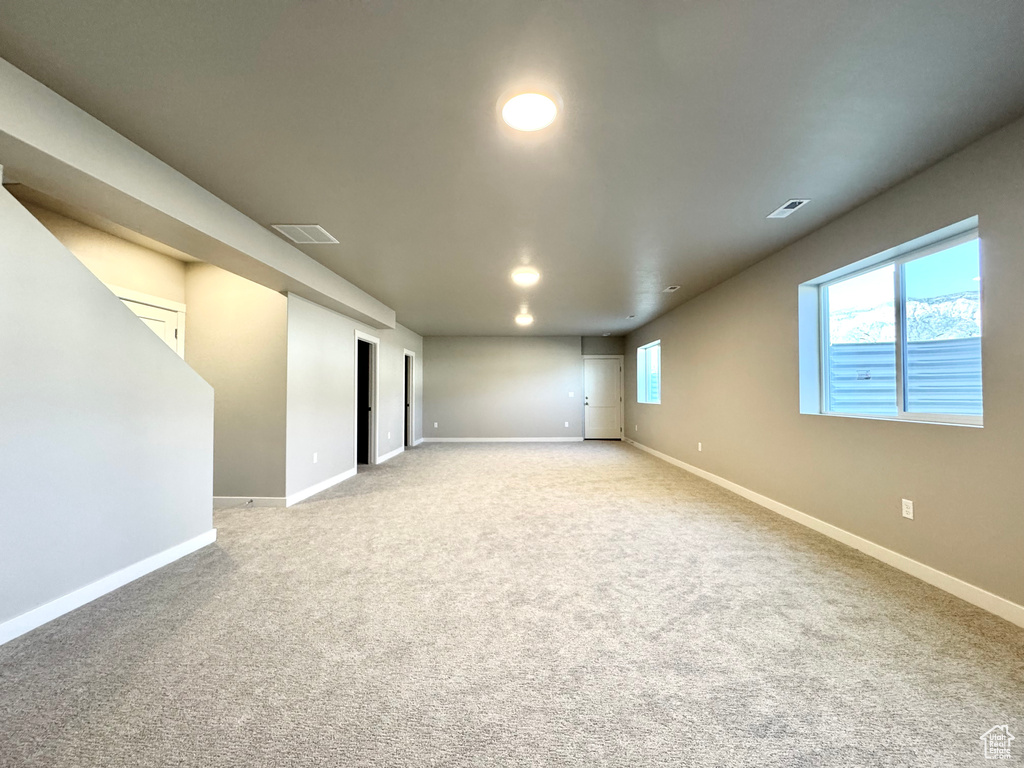 Carpeted empty room with baseboards and recessed lighting