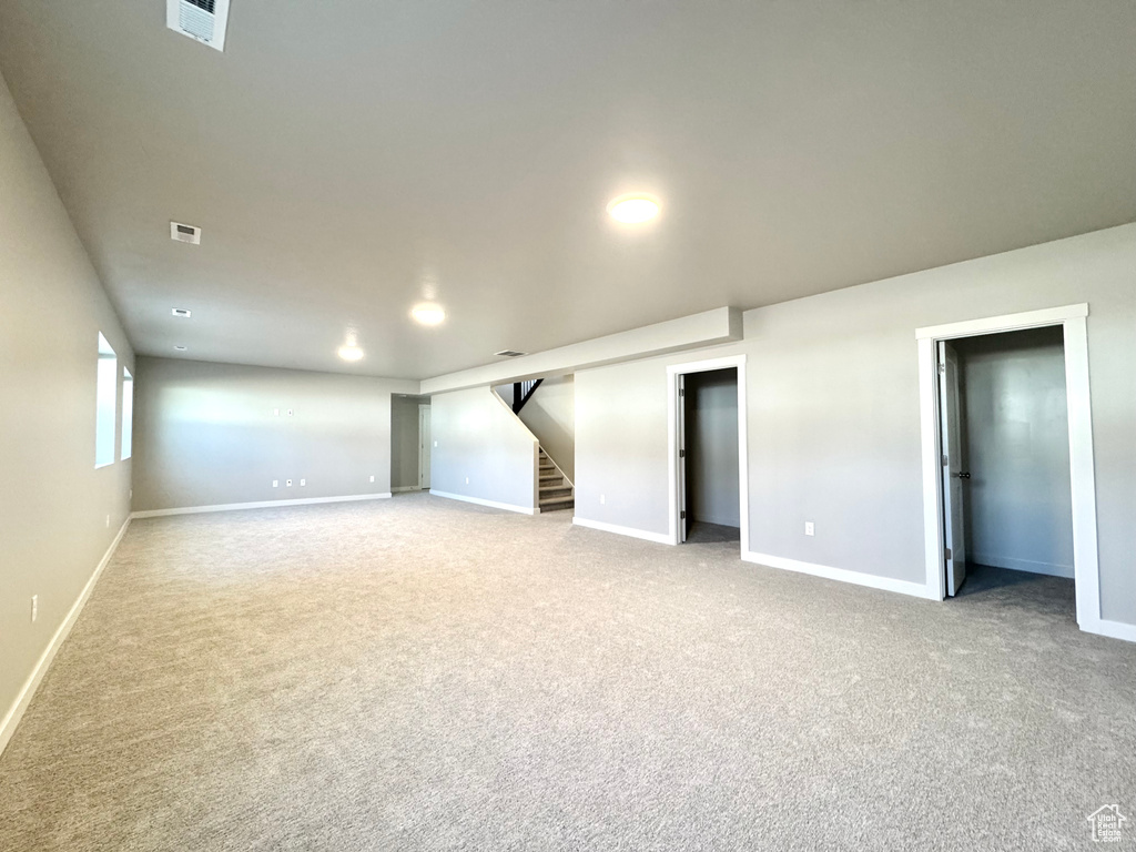 Below grade area with stairway, carpet, and recessed lighting