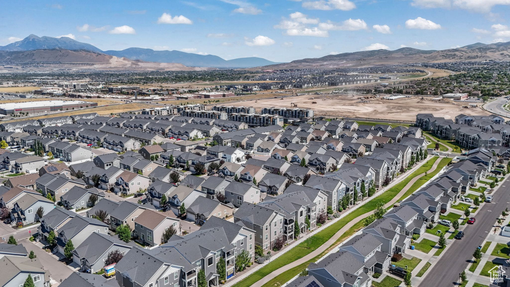 Aerial overview of property's location with a mountainous background and nearby suburban area