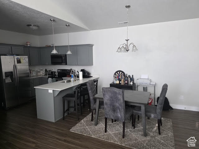 Dining area featuring a chandelier and dark wood finished floors