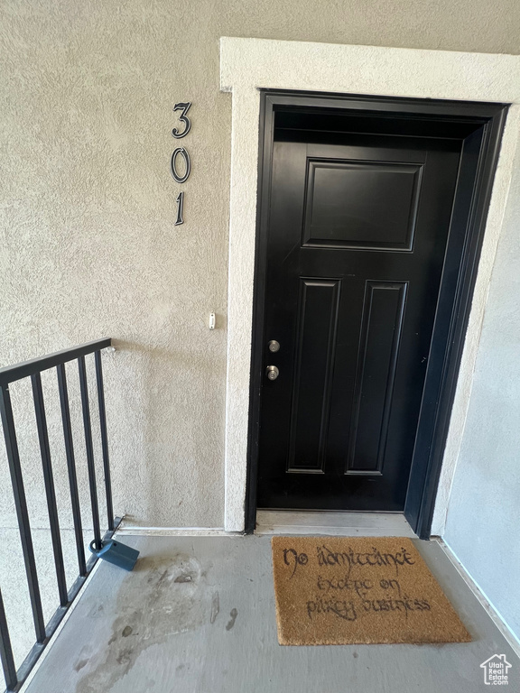 Entrance to property with stucco siding