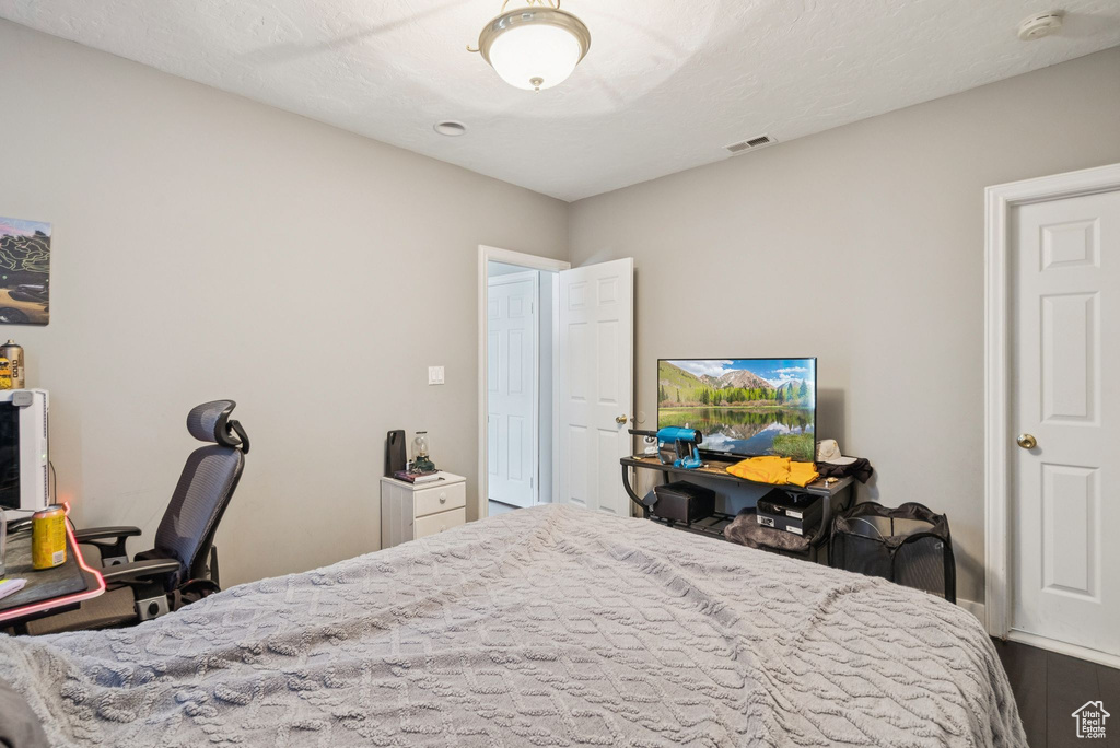 Bedroom with dark wood-style flooring