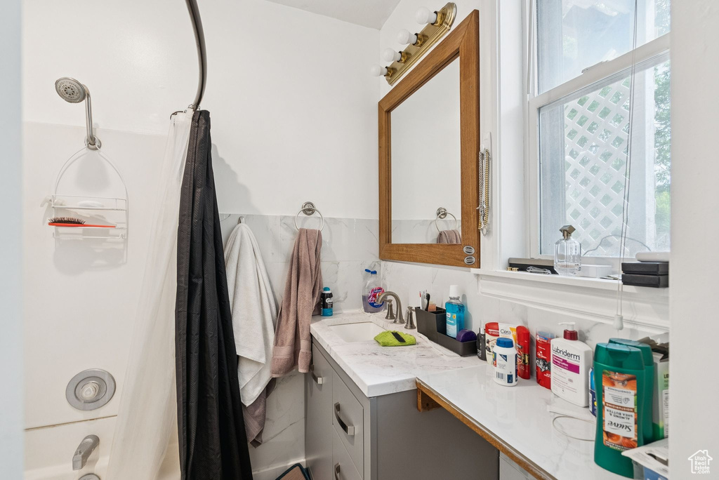 Bathroom featuring vanity and shower / tub combination
