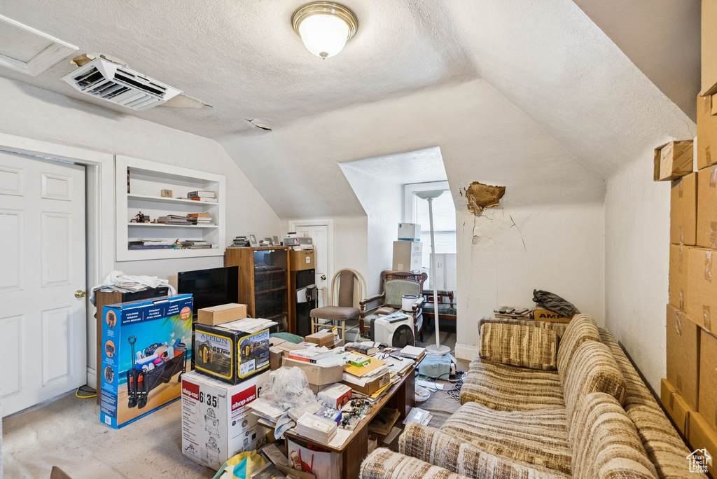 Office featuring lofted ceiling, a textured ceiling, and built in features