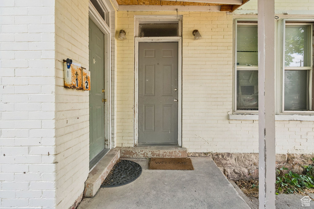 Doorway to property with brick siding