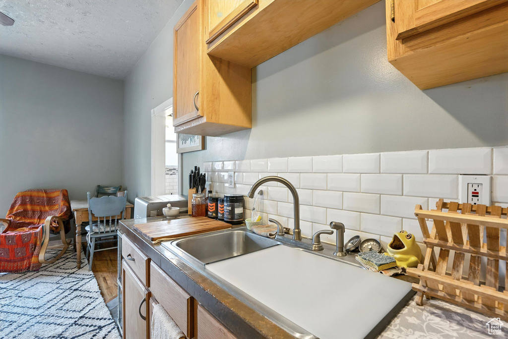 Kitchen featuring decorative backsplash and wood finished floors