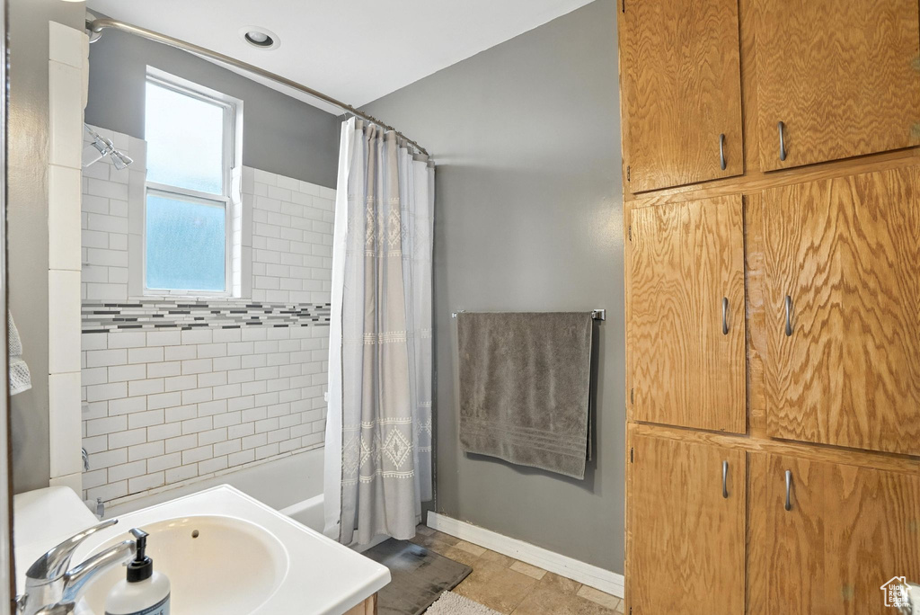 Full bathroom featuring shower / tub combo with curtain and vanity