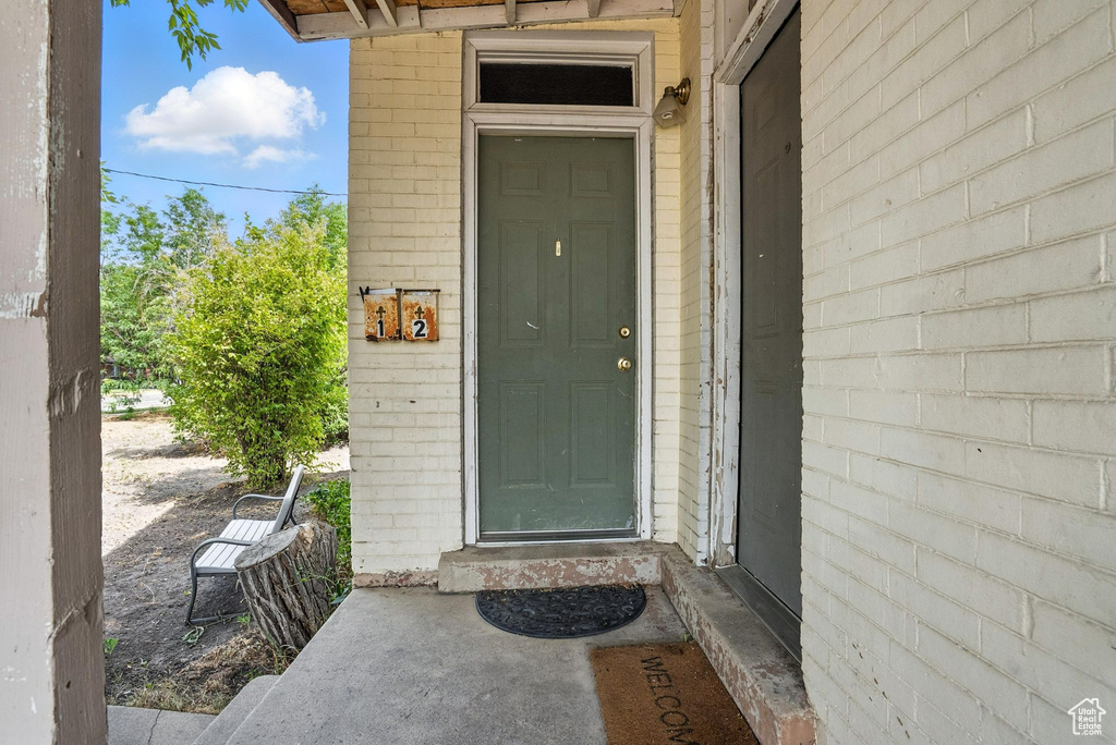 Entrance to property with brick siding