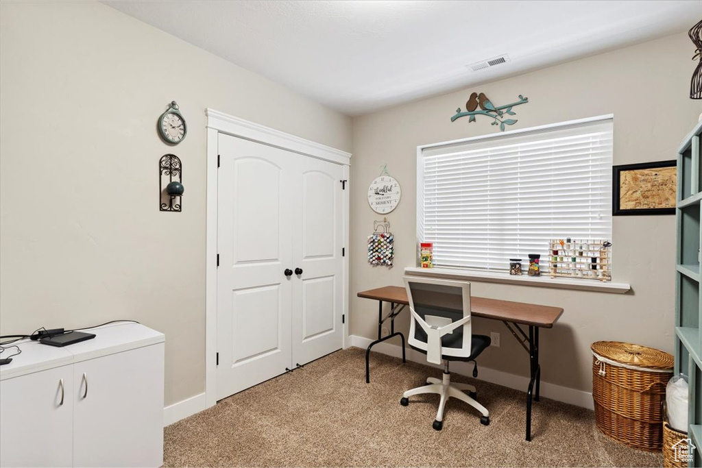Home office with carpet and baseboards