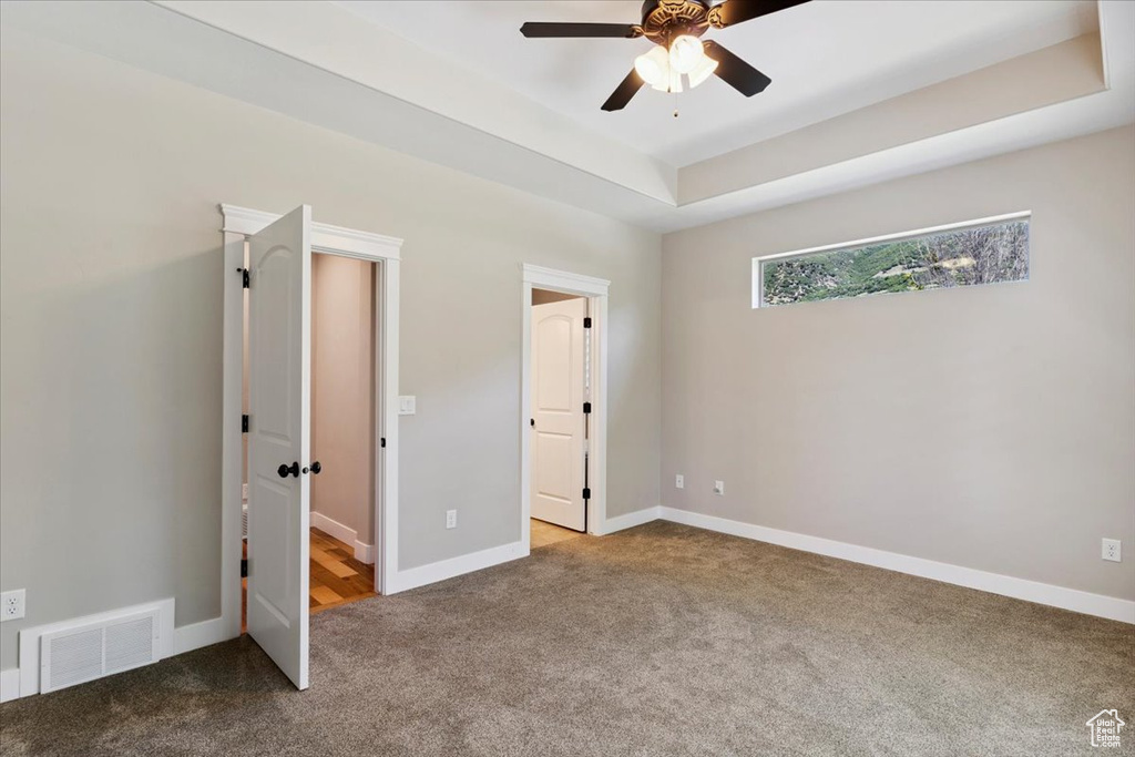 Unfurnished bedroom featuring carpet and a ceiling fan