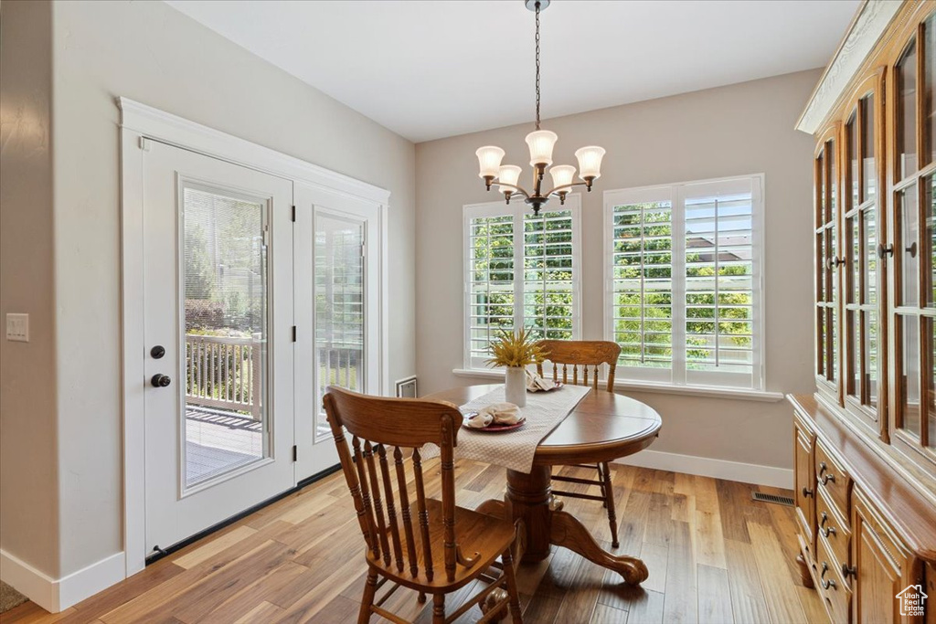 Dining room with a chandelier and light wood-type flooring