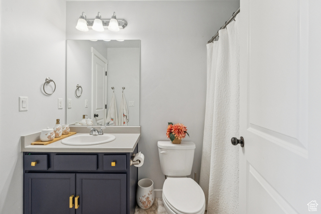 Full bath featuring vanity and toilet
