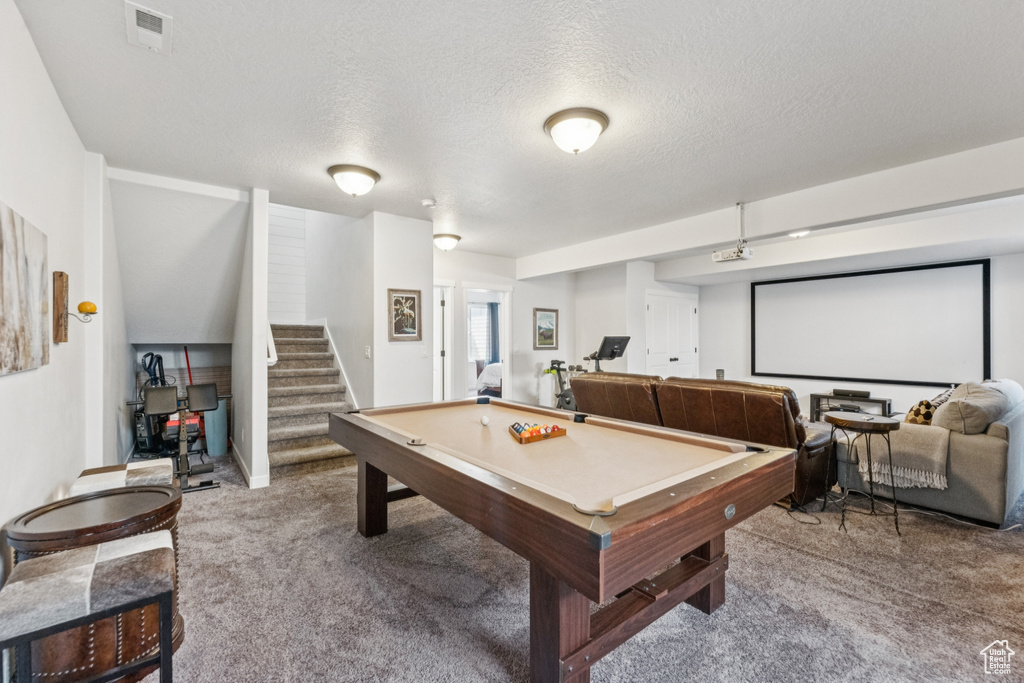 Playroom with carpet, pool table, and a textured ceiling