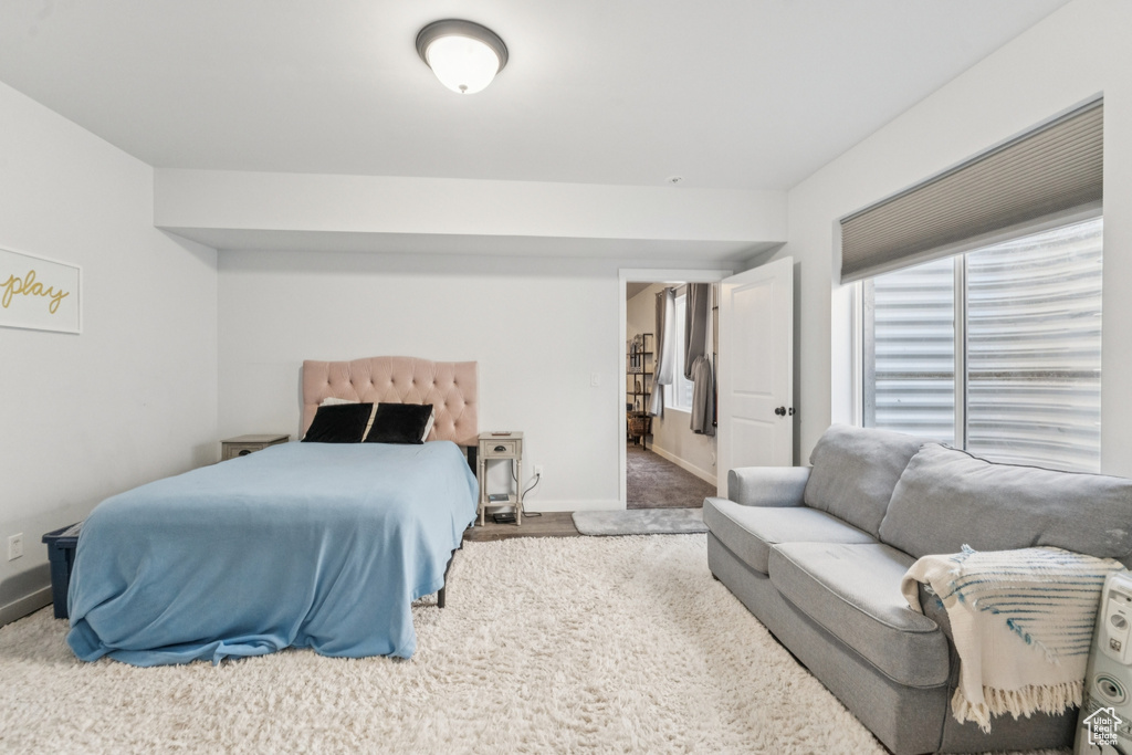 Bedroom featuring carpet floors and baseboards