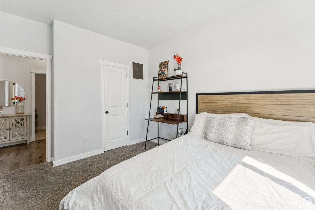 Bedroom featuring carpet and baseboards