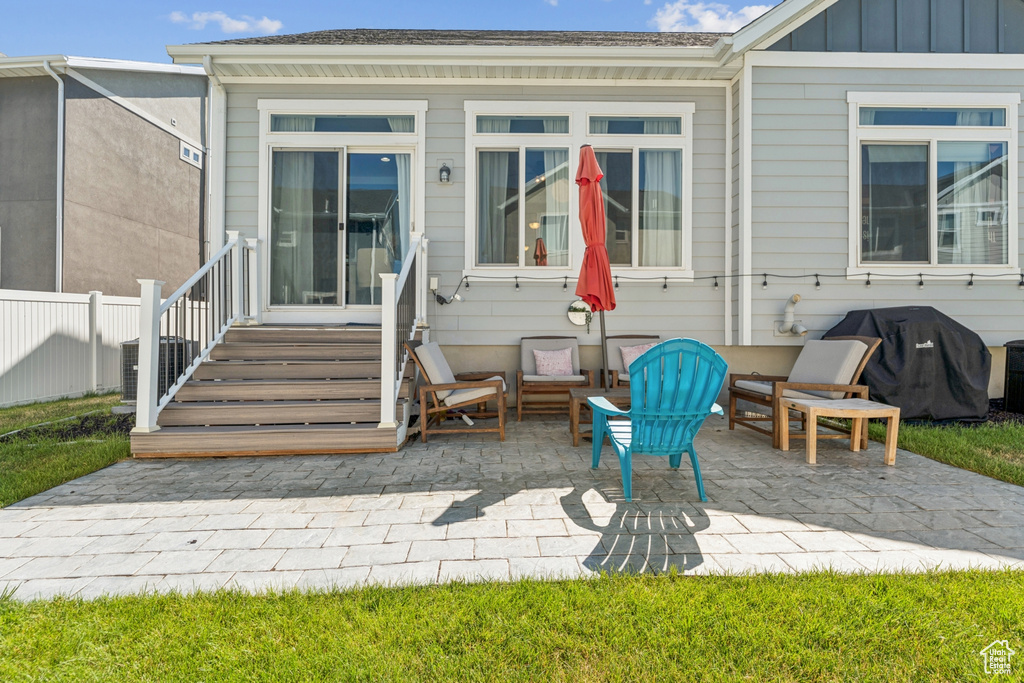 Back of property featuring a patio, board and batten siding, and entry steps