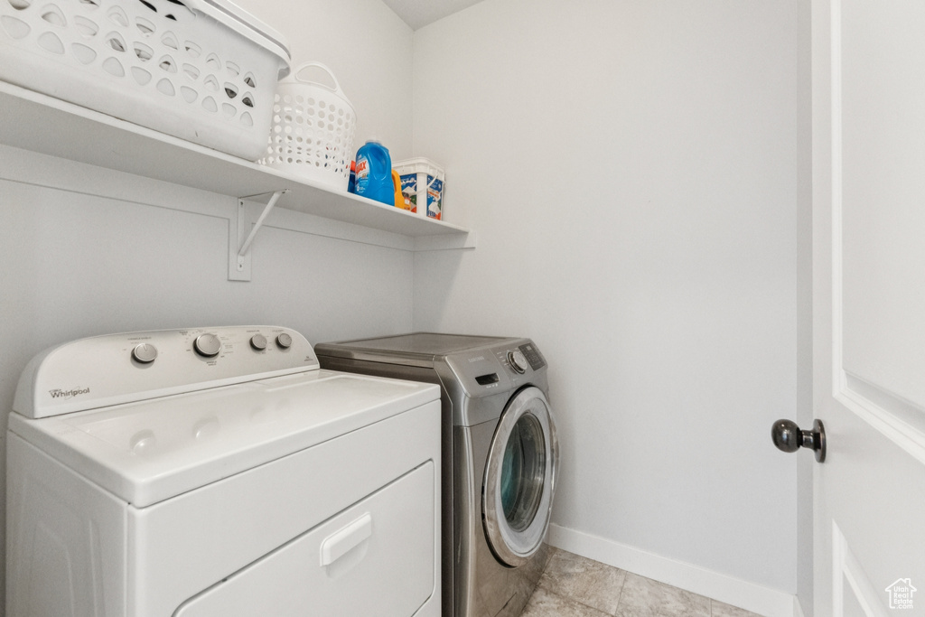 Laundry room featuring washer and dryer and baseboards