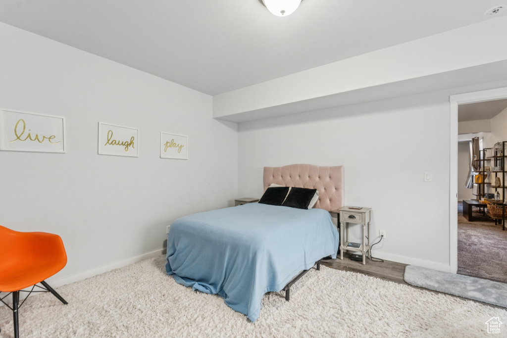 Carpeted bedroom featuring baseboards