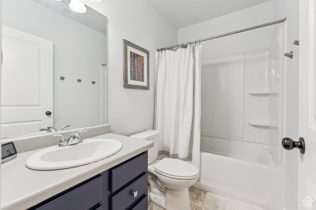 Full bathroom with vanity and shower / bath combination with curtain