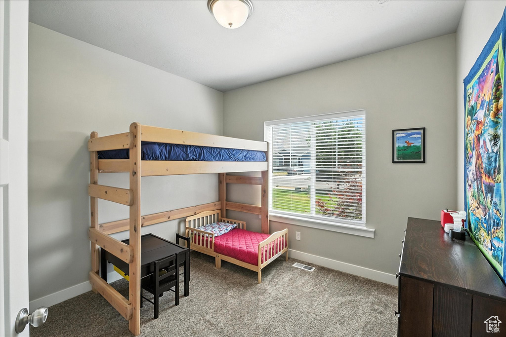Bedroom with baseboards and carpet