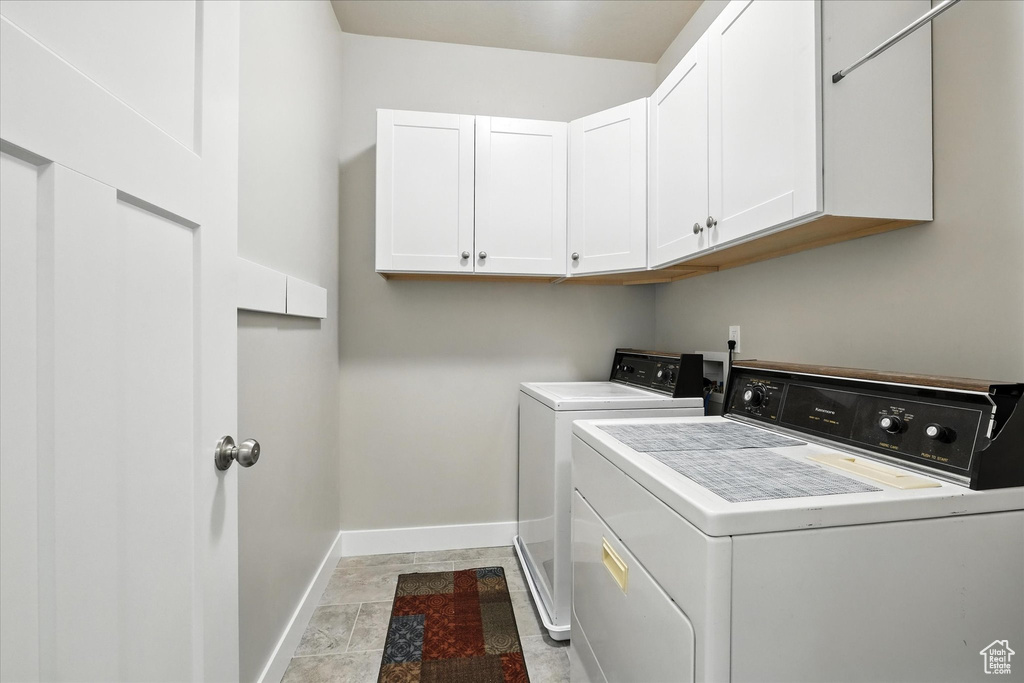 Laundry room featuring cabinet space and washer and clothes dryer