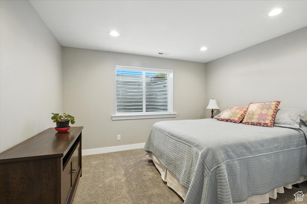 Bedroom with light carpet and recessed lighting