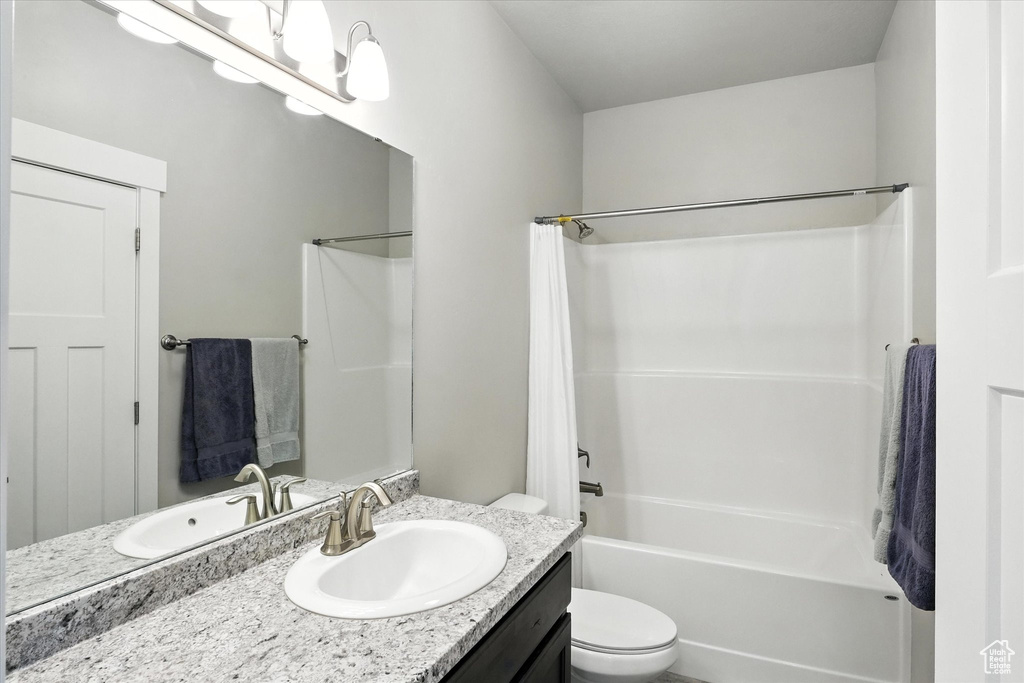 Full bath featuring vanity and shower / bath combo with shower curtain
