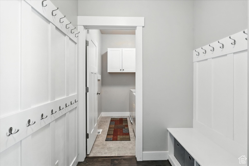 Mudroom with baseboards and dark wood-style floors