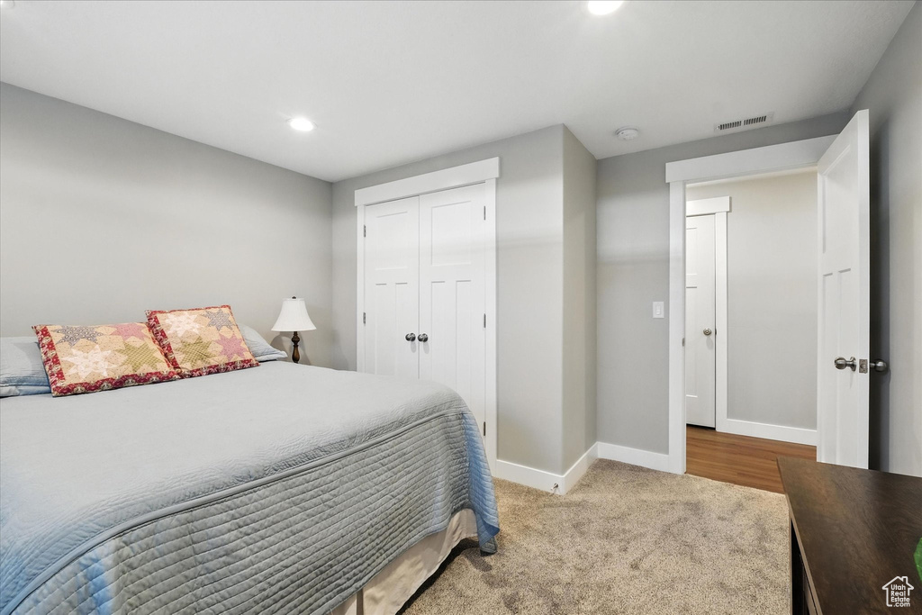 Bedroom featuring recessed lighting, carpet, and a closet