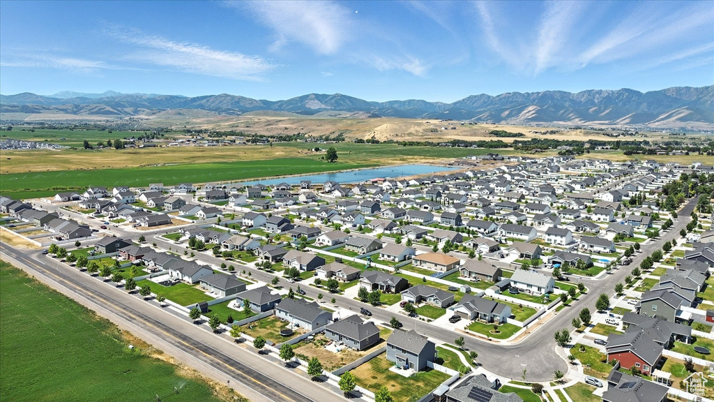 View of property location with a water and mountain view and nearby suburban area