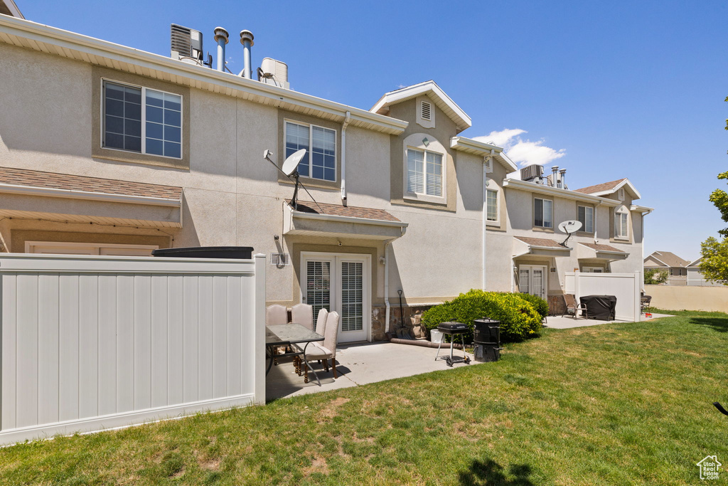Back of property featuring a patio, stucco siding, and a chimney