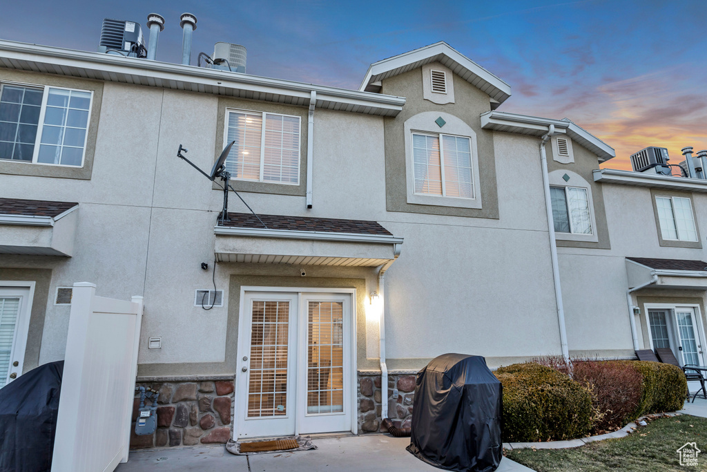 Back of property featuring stucco siding