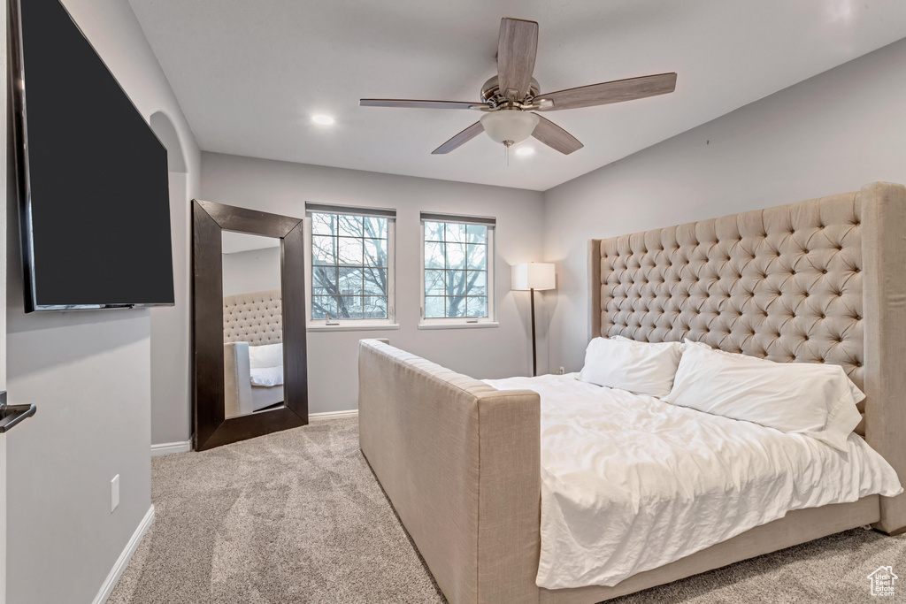 Bedroom featuring light carpet, ceiling fan, and recessed lighting
