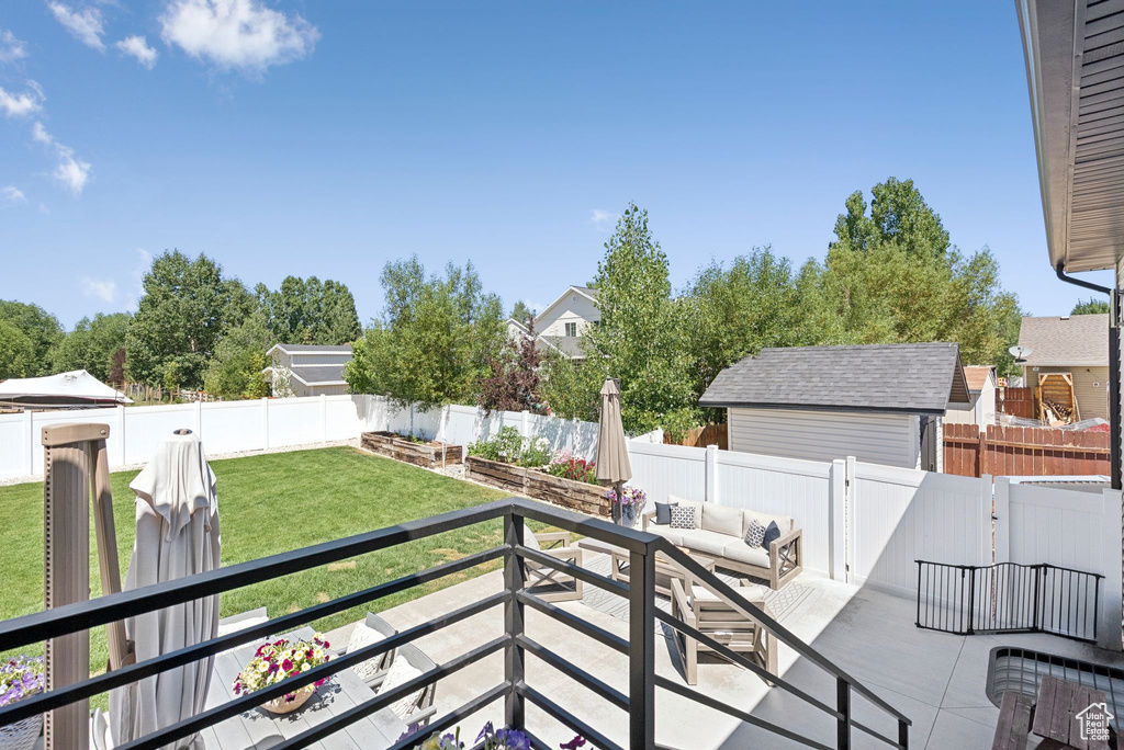Fenced backyard with an outdoor hangout area and a patio area