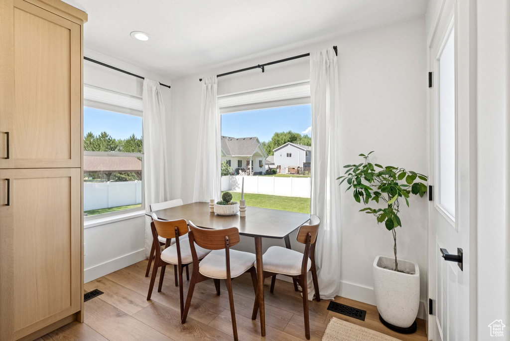 Dining area featuring plenty of natural light, light wood finished floors, and recessed lighting