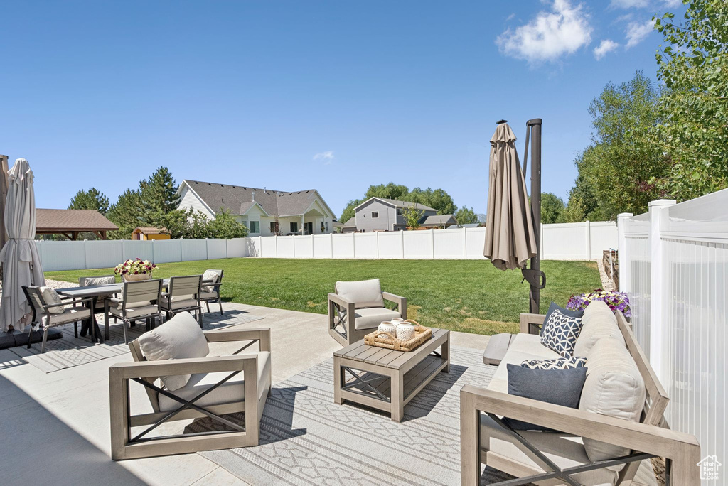 Fenced backyard featuring outdoor dining area and an outdoor hangout area