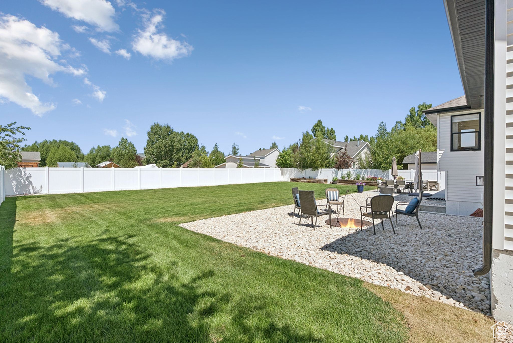 Fenced backyard with a patio area and a residential view