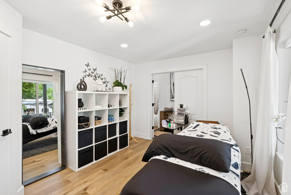Bedroom featuring wood finished floors, a chandelier, recessed lighting, and a closet