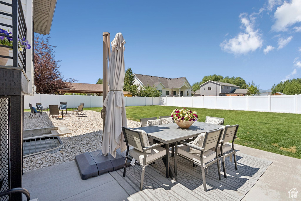 Fenced backyard featuring outdoor dining space and a patio area