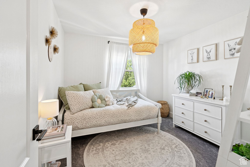 Bedroom featuring dark carpet