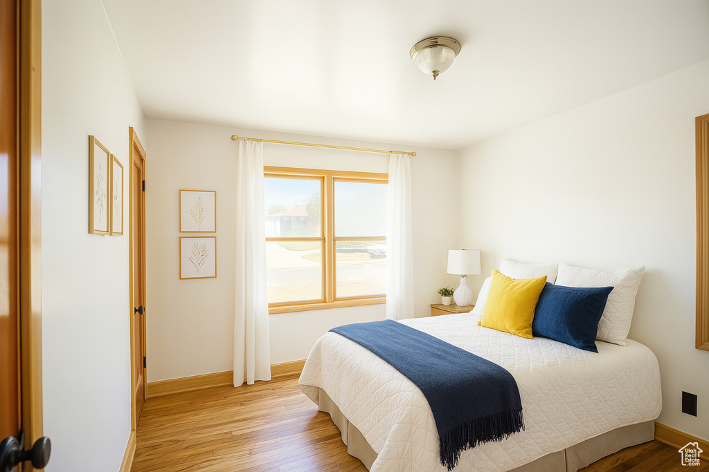 Bedroom with light wood-style floors and baseboards