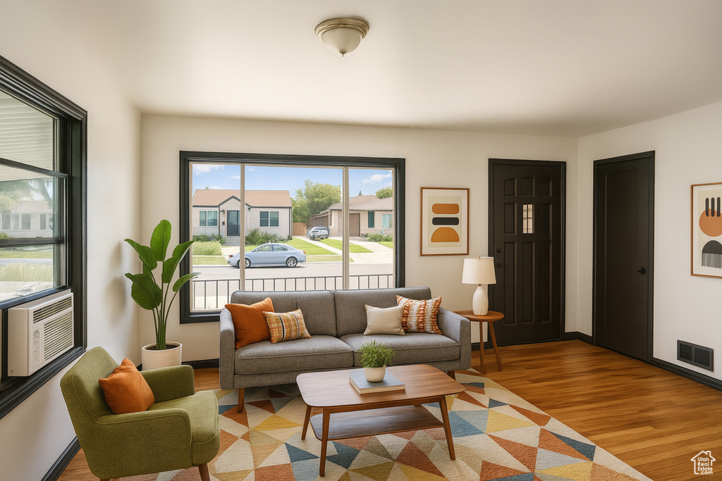 Living area featuring light wood-style flooring and cooling unit