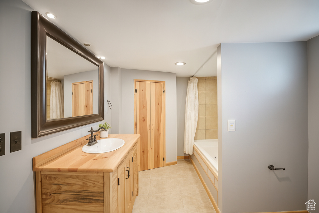 Bathroom featuring vanity, tile patterned flooring, recessed lighting, and shower / tub combo