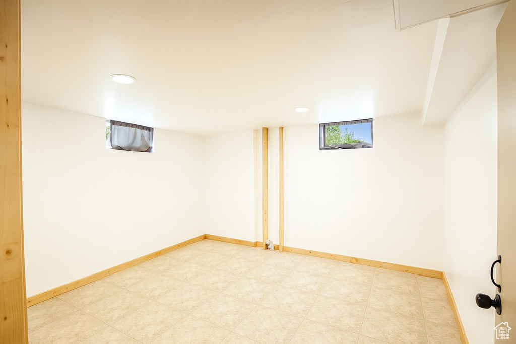 Basement with recessed lighting and light flooring