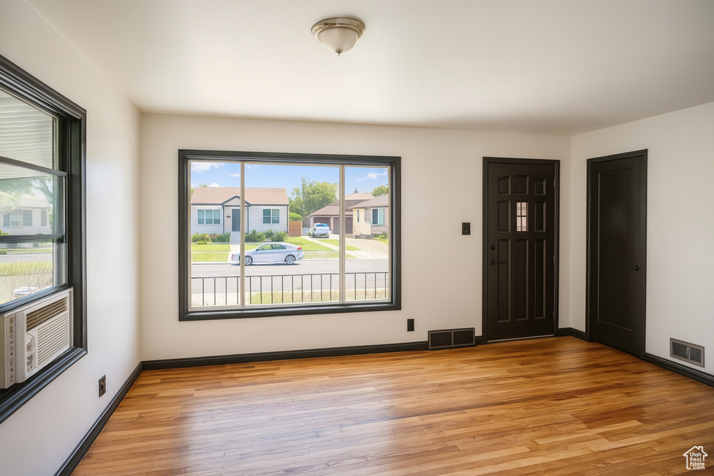 Unfurnished room with light wood finished floors and baseboards
