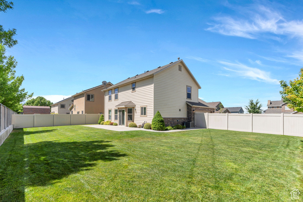 Back of house featuring a fenced backyard and a patio
