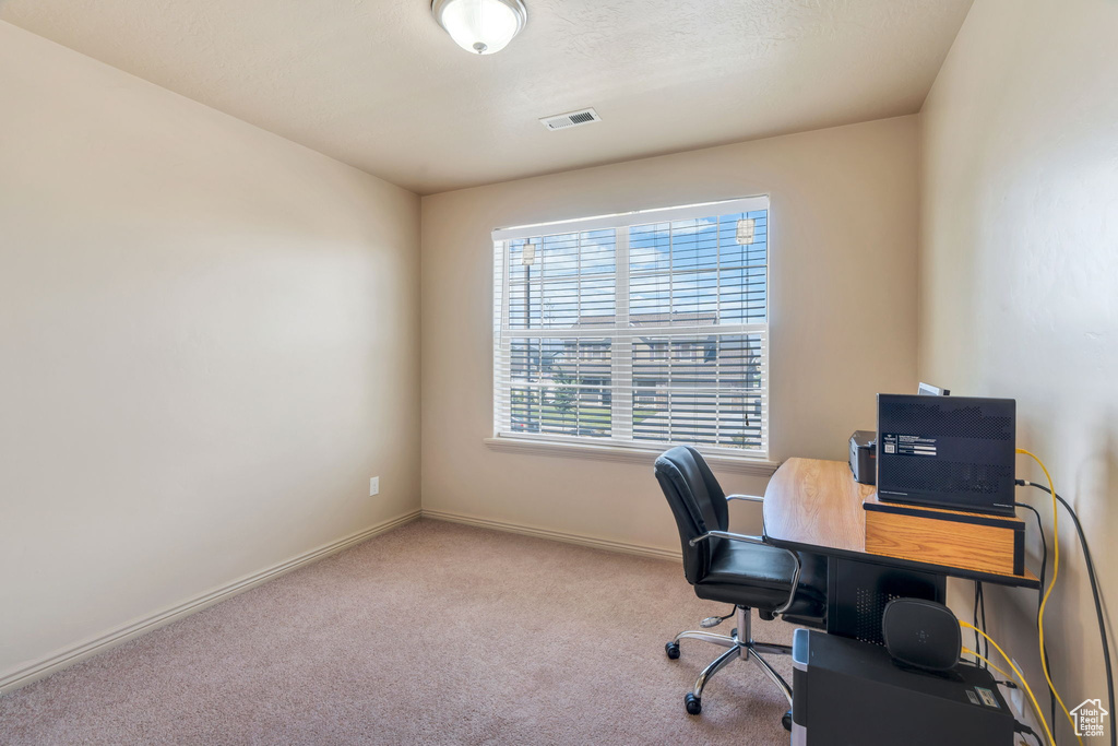 Carpeted office with baseboards
