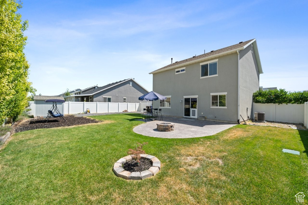 Rear view of house featuring an outdoor fire pit, a patio, a fenced backyard, and stucco siding