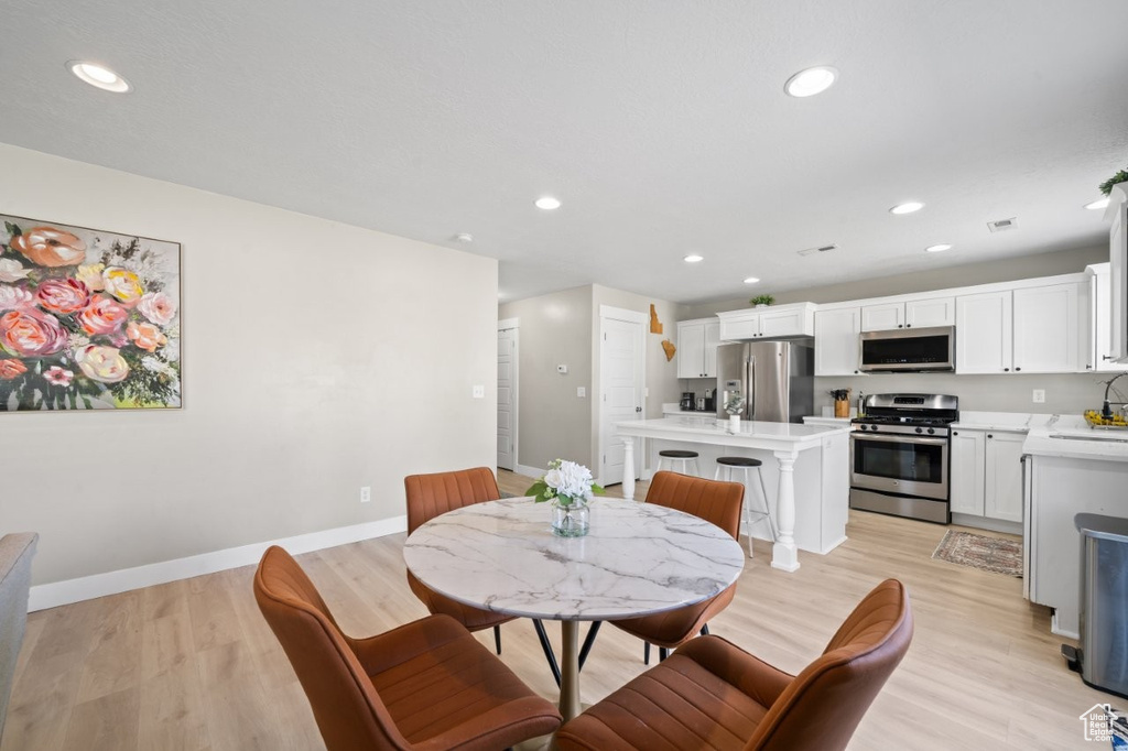 Dining room featuring light wood-style floors and recessed lighting