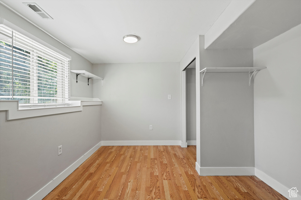 Walk in closet featuring light wood finished floors